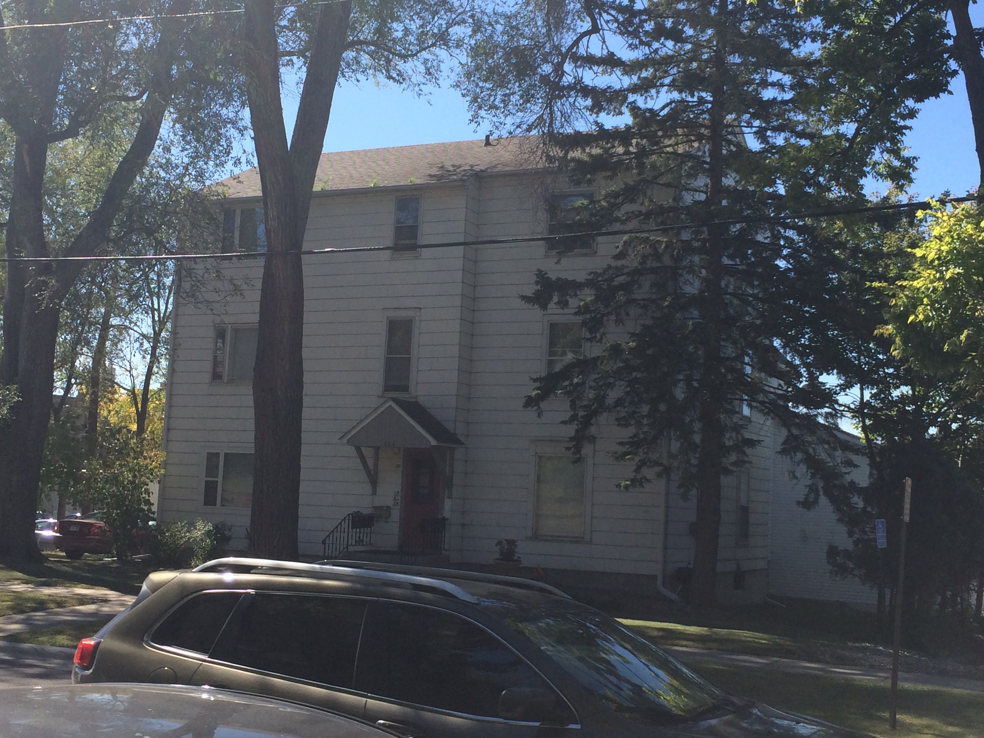 Picture of Large White Apartment Building between public parking lots.